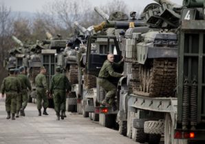 Ukrainian soldiers transport their tanks from their base in Perevalnoe, outside Simferopol, Crimea, Wednesday, March 26, 2014. Ukraine has started withdrawing its troops and weapons from Crimea, now controlled by Russia. (AP Photo/Pavel Golovkin)