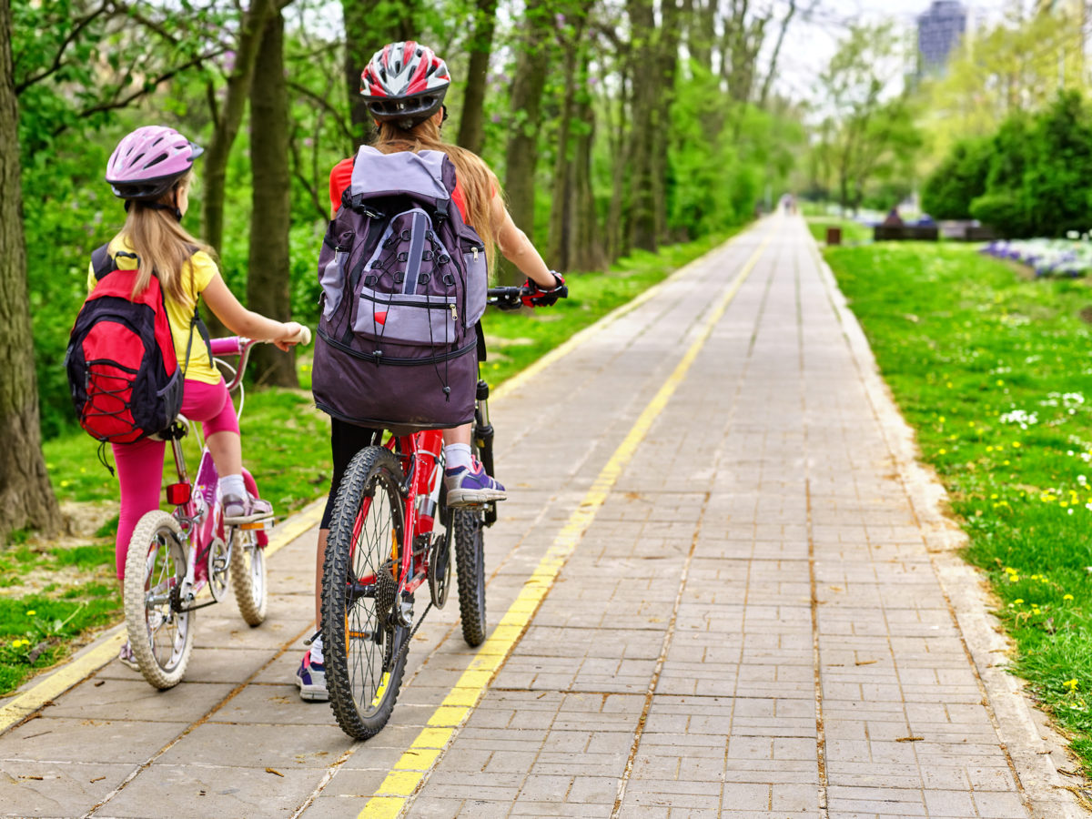 Girls riding on a bike lane well away from traffic