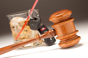 Gavel, Alcoholic Drink & Car Keys on a Gradating to White Backgr