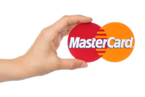 Hand holds Mastercard logo